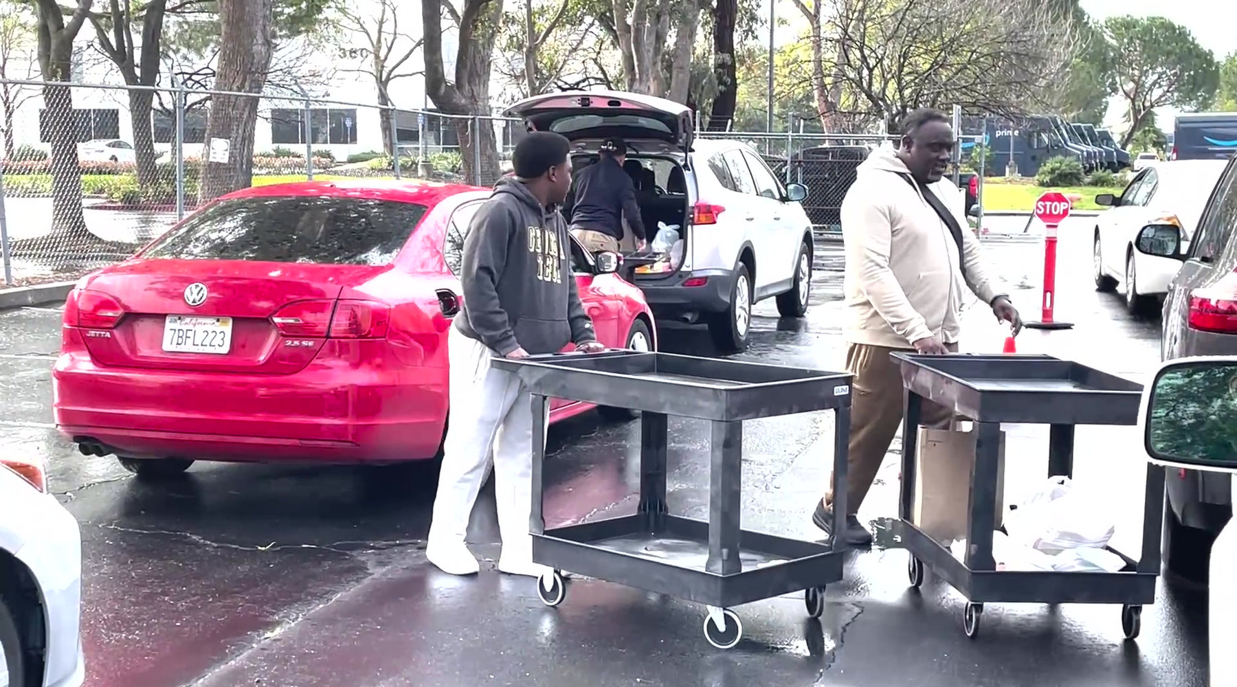 Volunteers loading supplies for families waiting in line